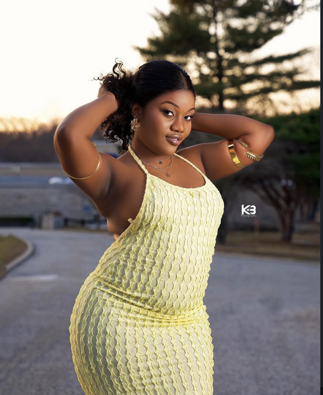 Golden hour outdoor lifestyle portrait of a woman in a yellow textured dress at sunset in New York, by KB Photography